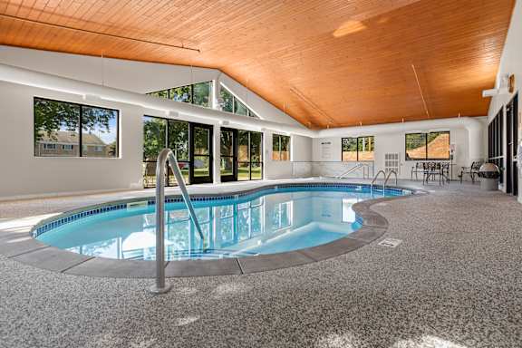 A large indoor swimming pool with a wooden ceiling.