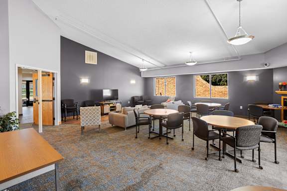 A room with a long table and chairs.
