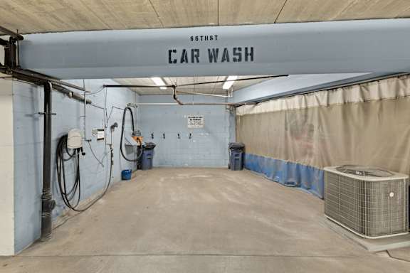A car wash station with a sign that says "Car Wash" on the ceiling.