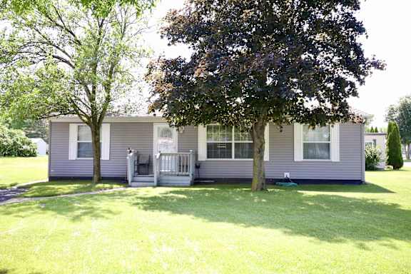 A house with a grey exterior and a white porch.