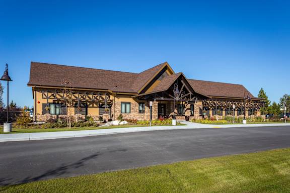 A building with a brown roof and a stone facade.