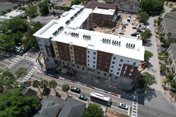 an aerial view of a building under construction on a city street