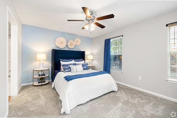 a swimming pool with chaise lounge chairs and a pool house in the background at Park Place Apartment Homes, Hattiesburg, MS, 39402