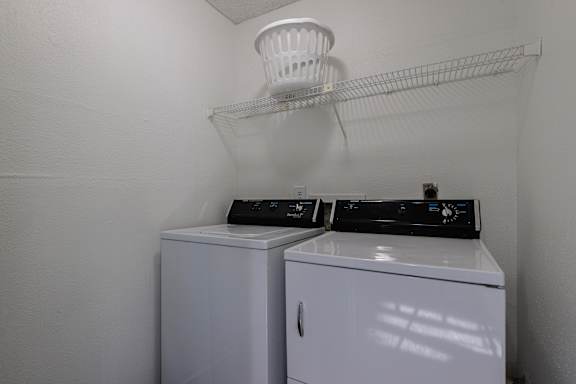 A laundry area in a model unit at Skyler Ridge Complex, featuring a washer & dryer hookups.
