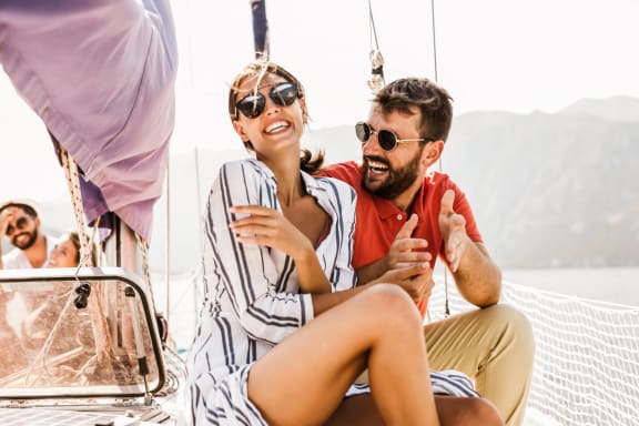 a man and a woman sitting on a sail boat