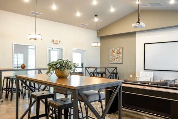 A conference room with a long table and chairs.