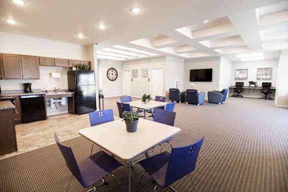A dining room with a table and chairs.