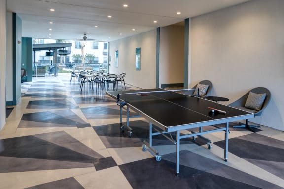 conference room with a ping pong table and chairs in the center of the room