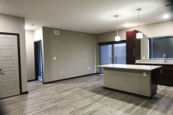 Kitchen featuring light granite countertops, dark cabinetry and stainless-steel appliances at North Pointe Villas best new apartments Lincoln NE 68521