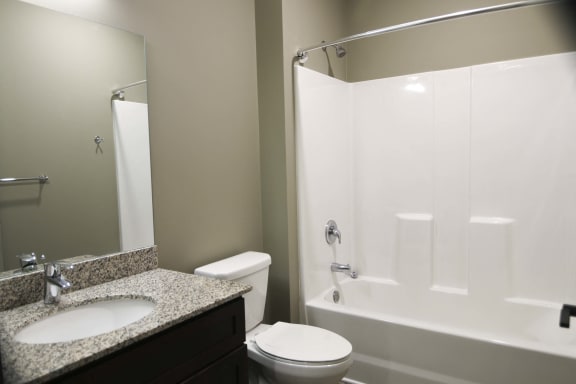 Spacious bathroom with tub shower and granite countertops in 2 bedroom apartment for rent at North Pointe Villas best new apartments Lincoln NE 68521