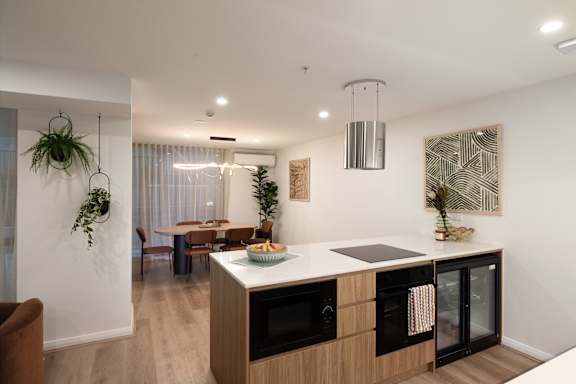 A modern kitchen with wooden cabinets and a large island.