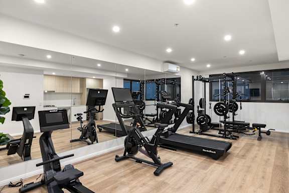 A spacious home gym with a variety of exercise equipment.