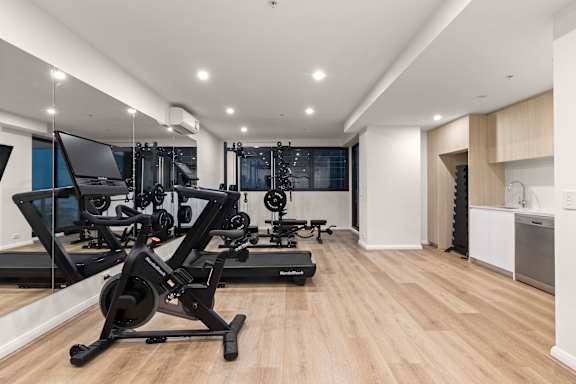 A modern home gym with a variety of exercise equipment.