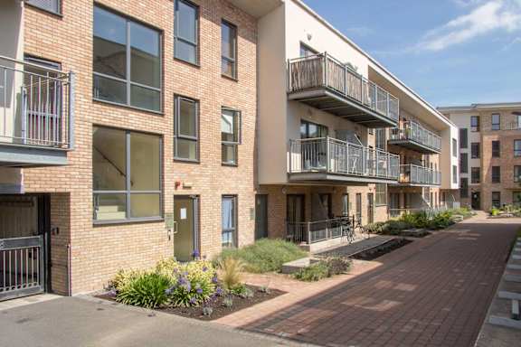 an exterior view of a brick apartment building with balconies