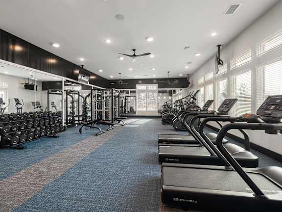 A gym with treadmills and exercise bikes.