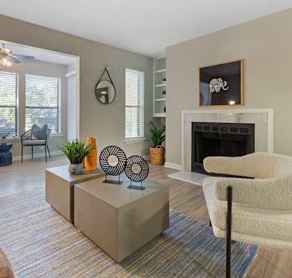 A living room with a fireplace and a chair.