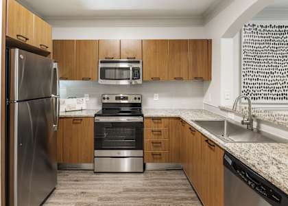 a kitchen with stainless steel appliances and granite counter tops