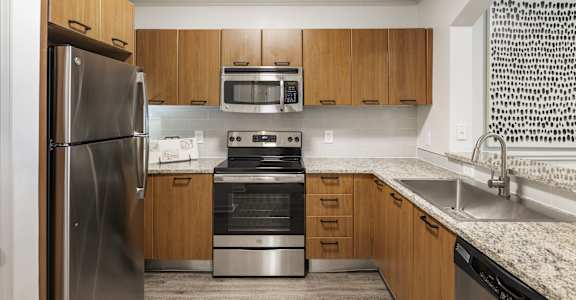 a kitchen with stainless steel appliances and granite counter tops