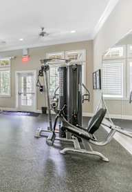 A spacious gym with treadmills, elliptical machines, and a weight machine.