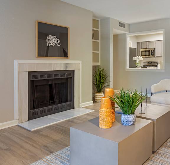 A living room with a fireplace and a chair.