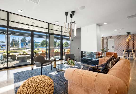 a living room filled with furniture and a large window