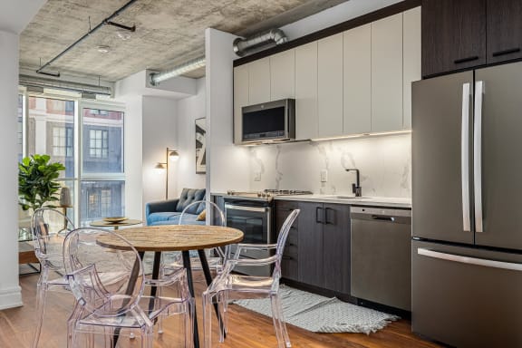 a kitchen and dining area with a table and chairs at 150 Marketplace, Ottawa, K2J 5R5