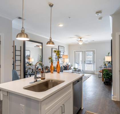 A kitchen with a sink and a counter.