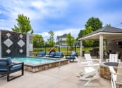 Thumbnail 8 of 11 - Sparkling pool and hot tub at Quarry Apartments and Townhomes in DeWitt, Michigan