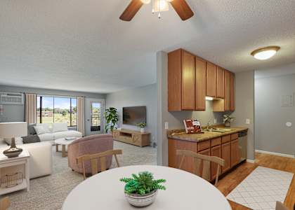 A living room with a couch, chair, and a table with a plant on it at Heritage Hills Apartments, Bloomington, 55437