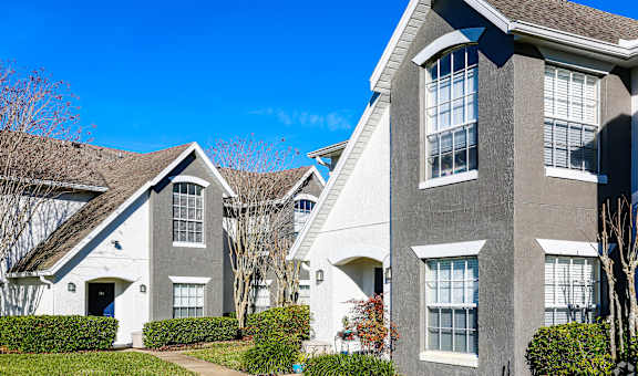 A row of houses with a clear blue sky above them.