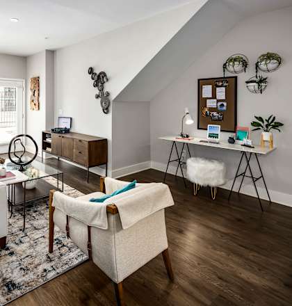 a living room with couches and chairs and a desk