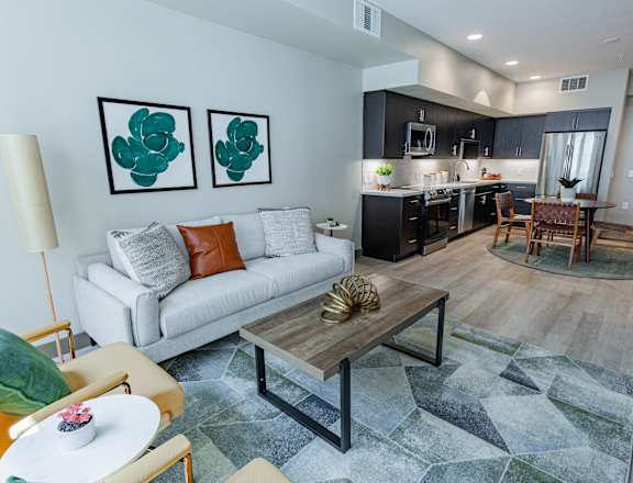 A modern living room with a white couch and a coffee table.