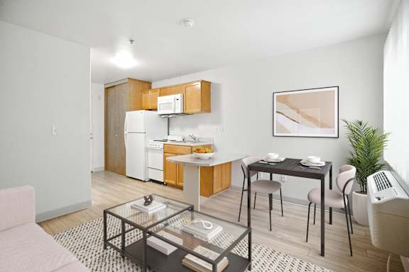 A modern kitchen with a dining table and chairs.