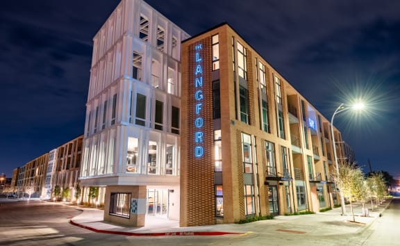 a night view of a building with a neon sign that reads welcome