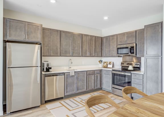a kitchen with dark wood cabinets and white countertops