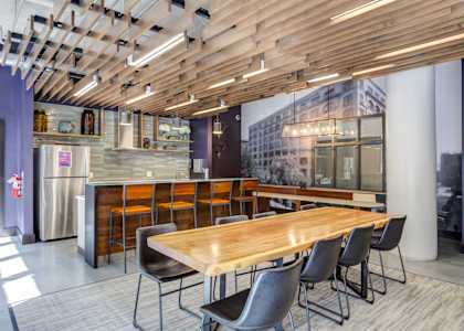 a dining room with a wooden table and chairs  at The Cosmopolitan, Minnesota, 55101