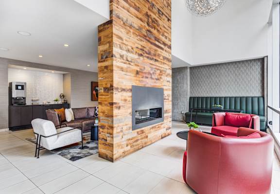 A modern living room with a fireplace and a green couch.
