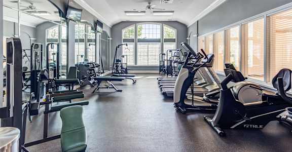 a gym with cardio machines and other exercise equipment
