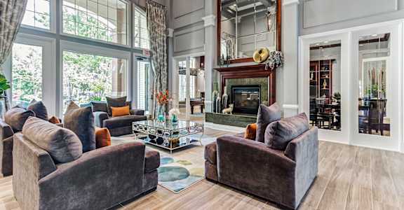 a large living room with couches and a fireplace