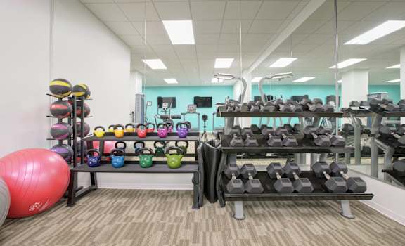 a variety of weights and other exercise equipment on display in a gym at The Equitable Building, Des Moines, IA, 50309