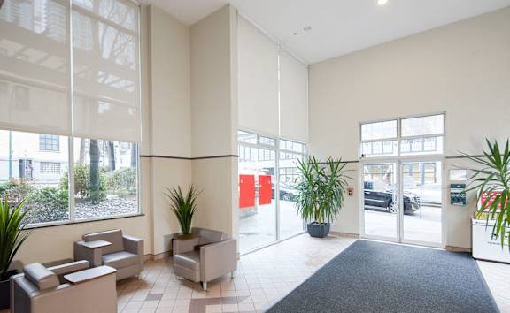 A waiting area with chairs and plants.