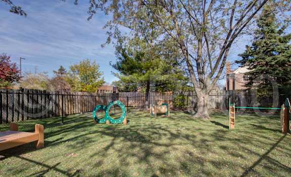 A playground with a swing set and a seesaw.