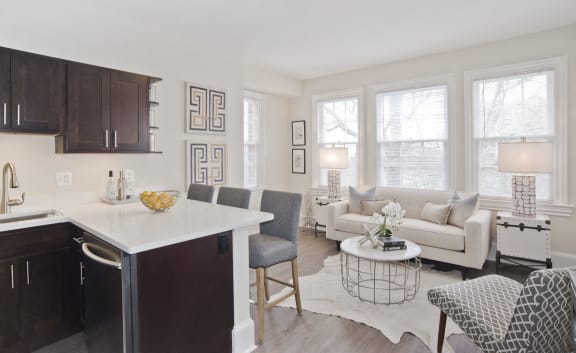 a living room with a kitchen and a couch and a table