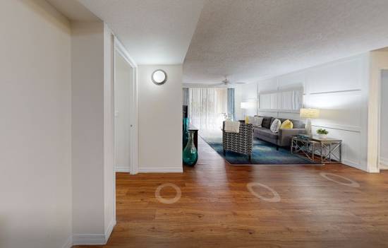 A white door with a sign that says "Presented by Atlantic Pacific" is in a room with white walls.
