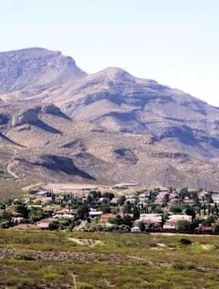 A mountain range with a small town in the foreground.