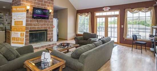 a living room with couches a coffee table and a fireplace