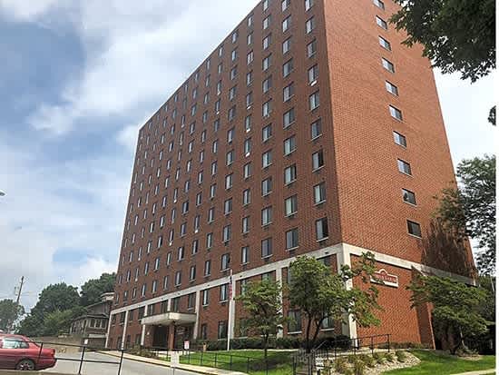 a tall brick building on the side of a street