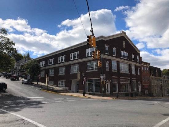 a large red brick building on the corner of a street