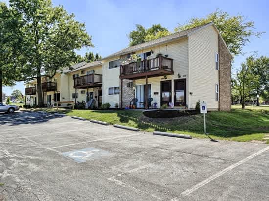 a parking lot in front of an apartment building
