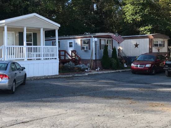 a mobile home with a car parked in front of it